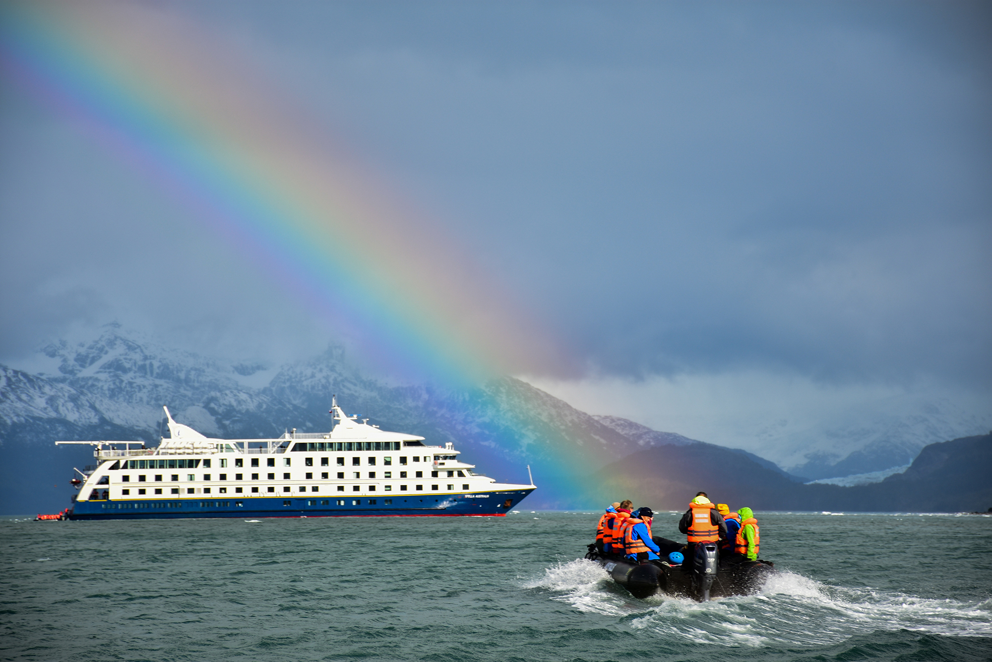Stella Australis, Patagonian cruising vessel with Zodiac excursion vessel under rainbow, Patagonia