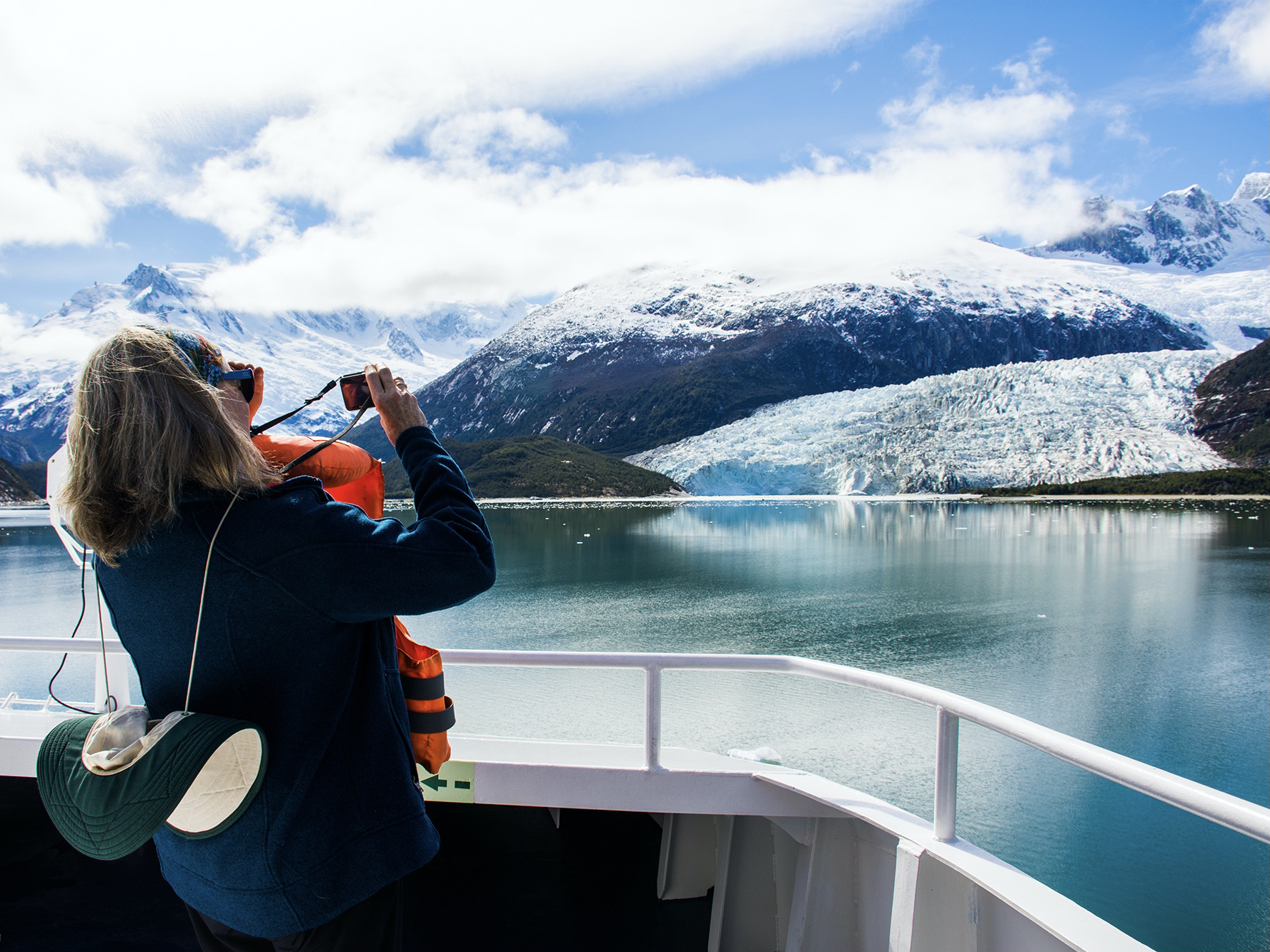 Cruise passenger takes photo of a glacier from an Australis ship