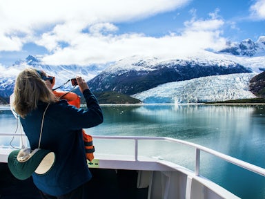 Cruise passenger takes photo of a glacier from an Australis ship