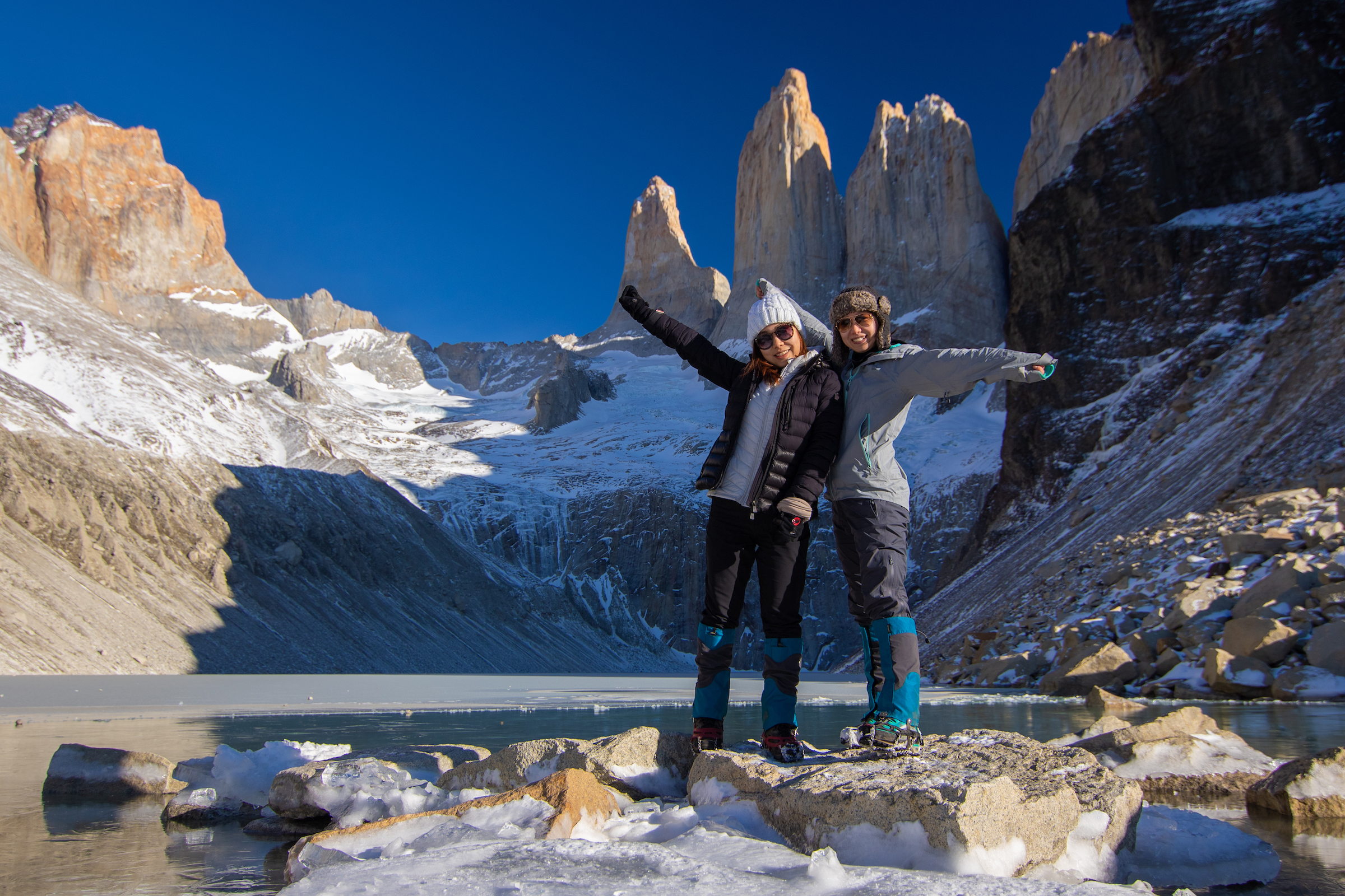 Two hikers at the Torres del Paine towers in winter