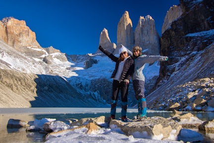 Two hikers at the Torres del Paine towers in winter