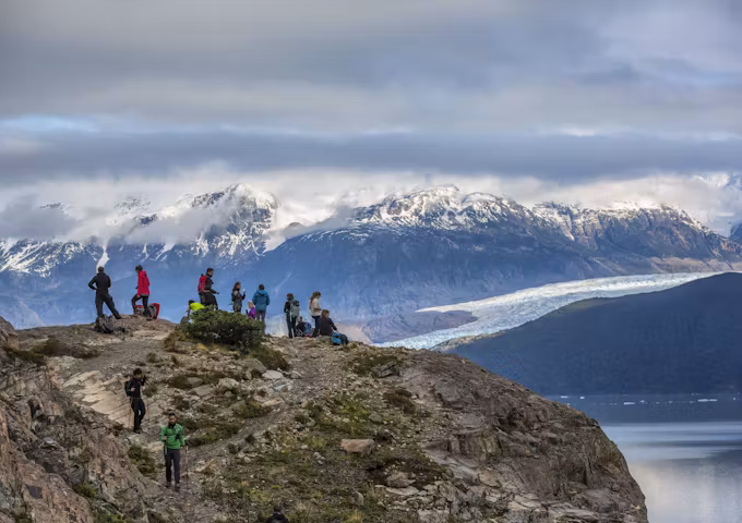 Group of hikers standing on the Glacier Grey Viewpoint looking at glaciers and mountains, Group Hiking, Torres del Paine Hike, Chile