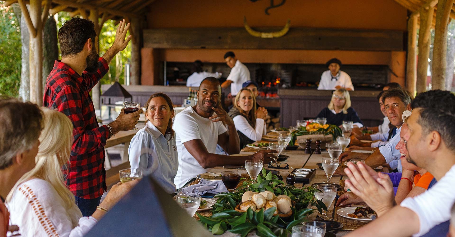A group of people enjoy meals at La Bamba de Areco near Buenos Aires, Argentina