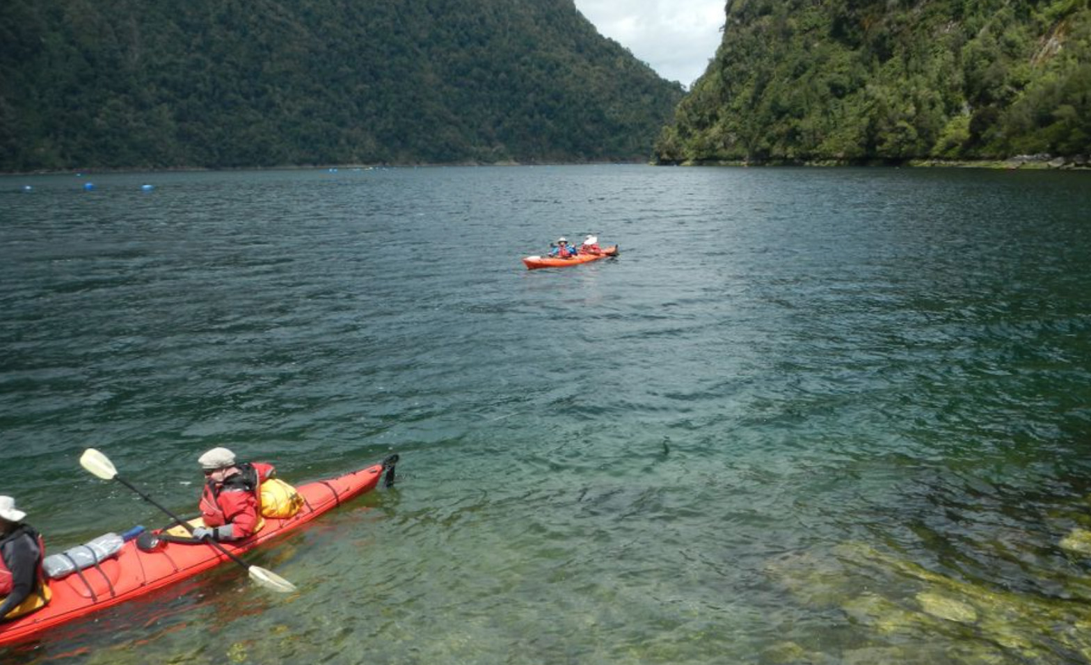 Kayaking crystal clear waters in Pumalín Park, Patagonia, Chile