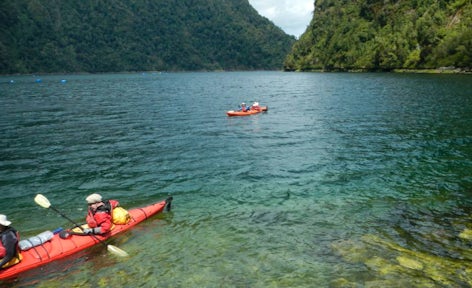 Kayaking crystal clear waters in Pumalín Park, Patagonia, Chile