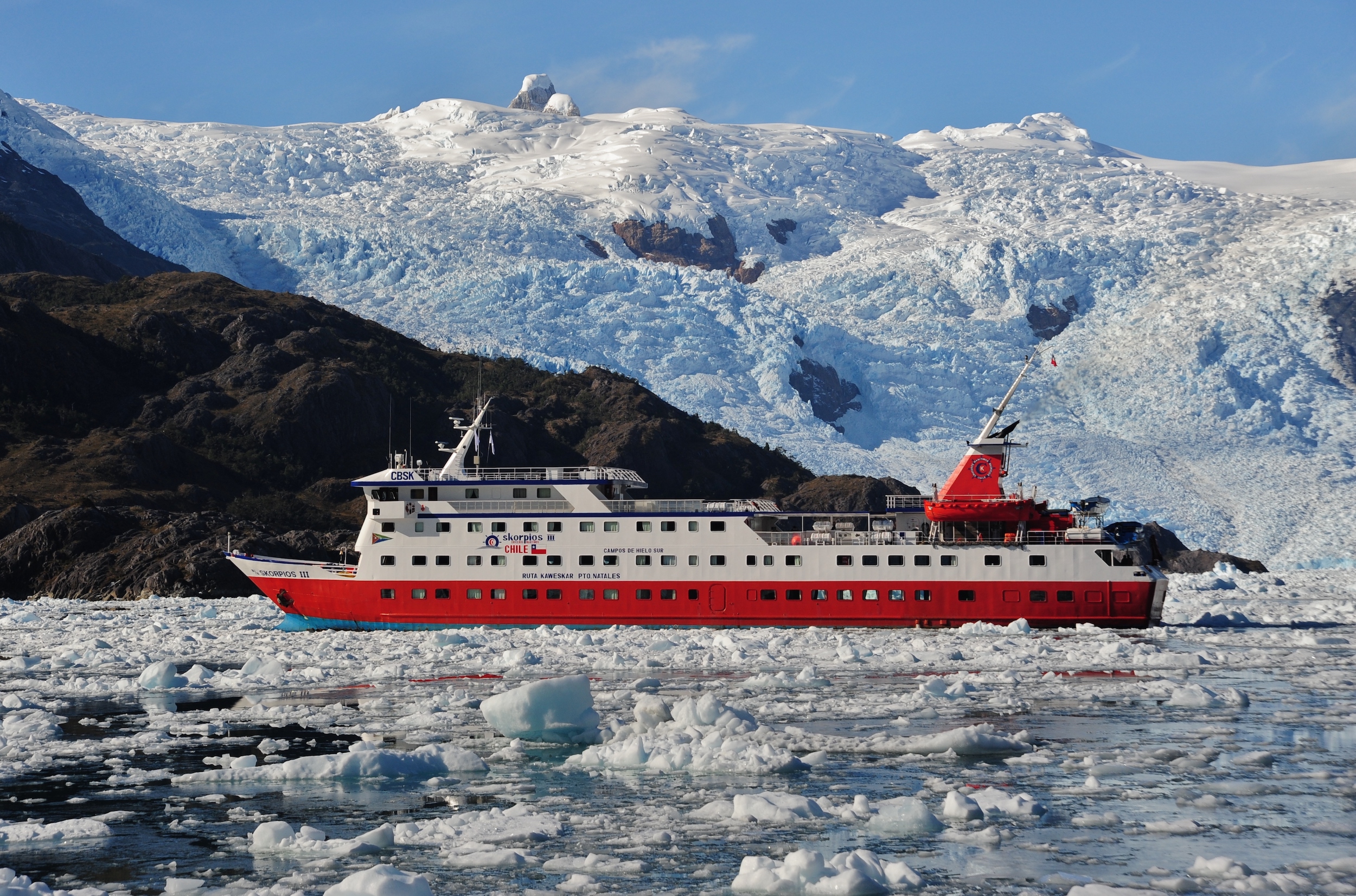 Skorpios III cruise ship in the Southern Chilean Fjords, against a glacier backdrop