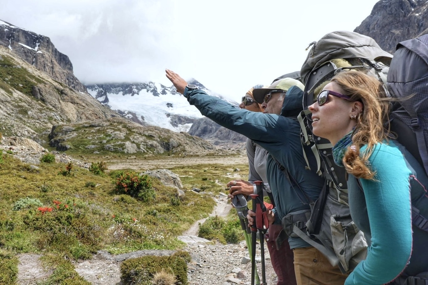 Guide pointing on the trail to a hiker on the Huemul Circuit trek