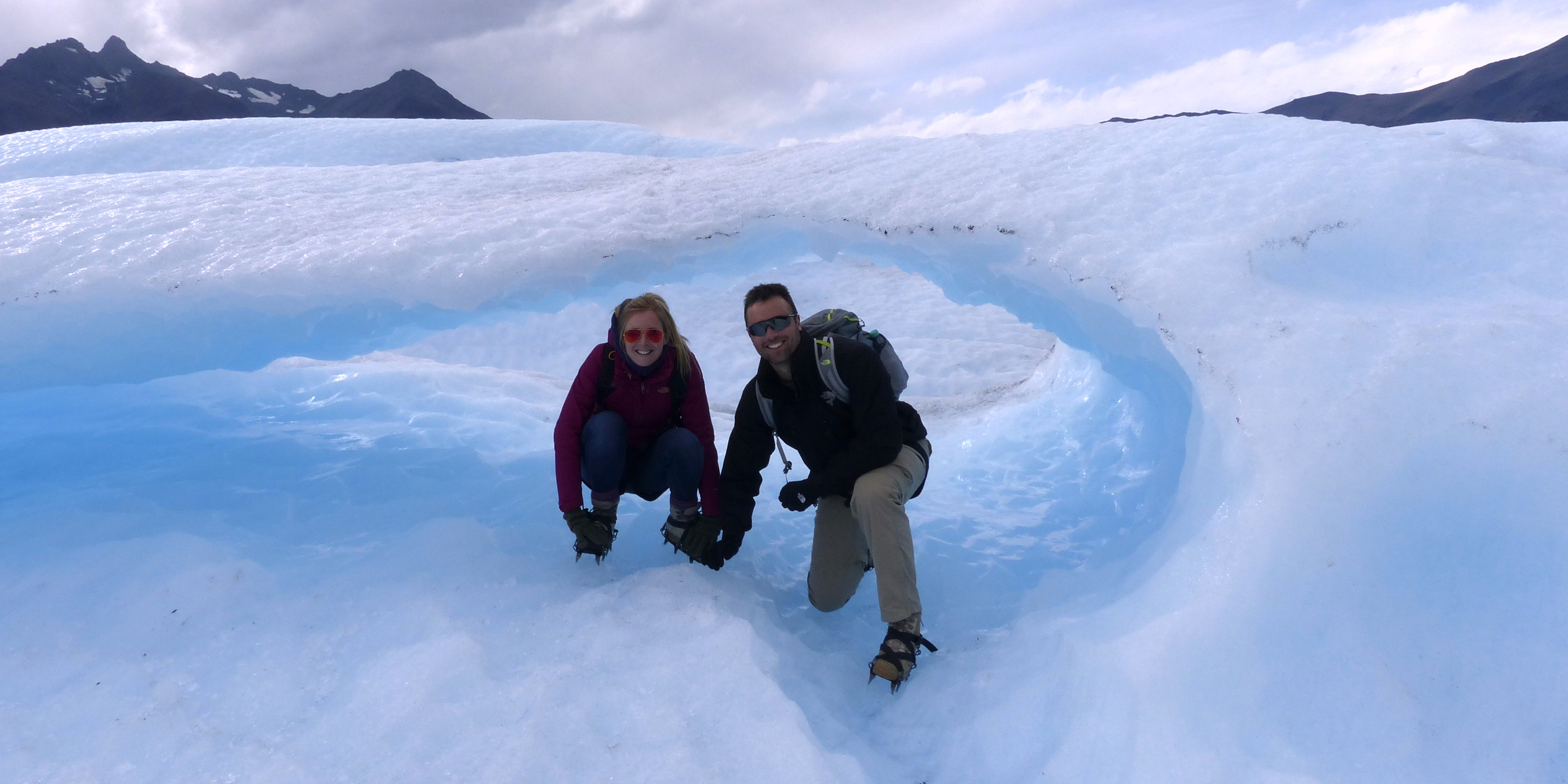 Two hikers in an ice cave on the surface of Perito Moreno