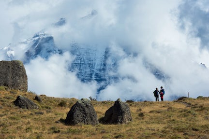 Hikers with Torres del Paine massif in clouds