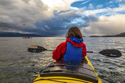 Kayaking the bays of Navarino Island near Puerto Williams in Chilean Tierra del Fuego