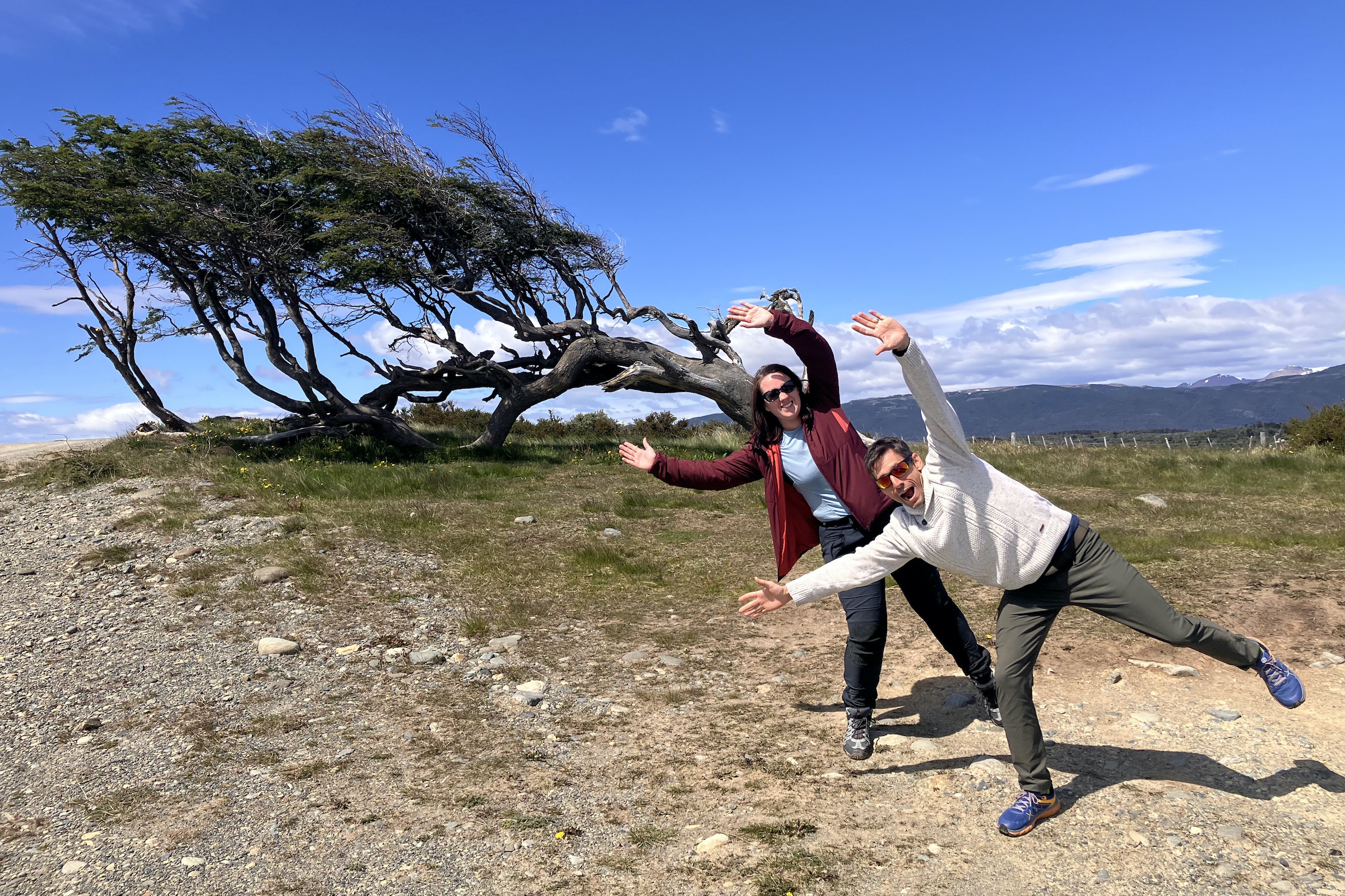 Tourists by the flag trees on the Beagle Channel in Tierra del Fuego