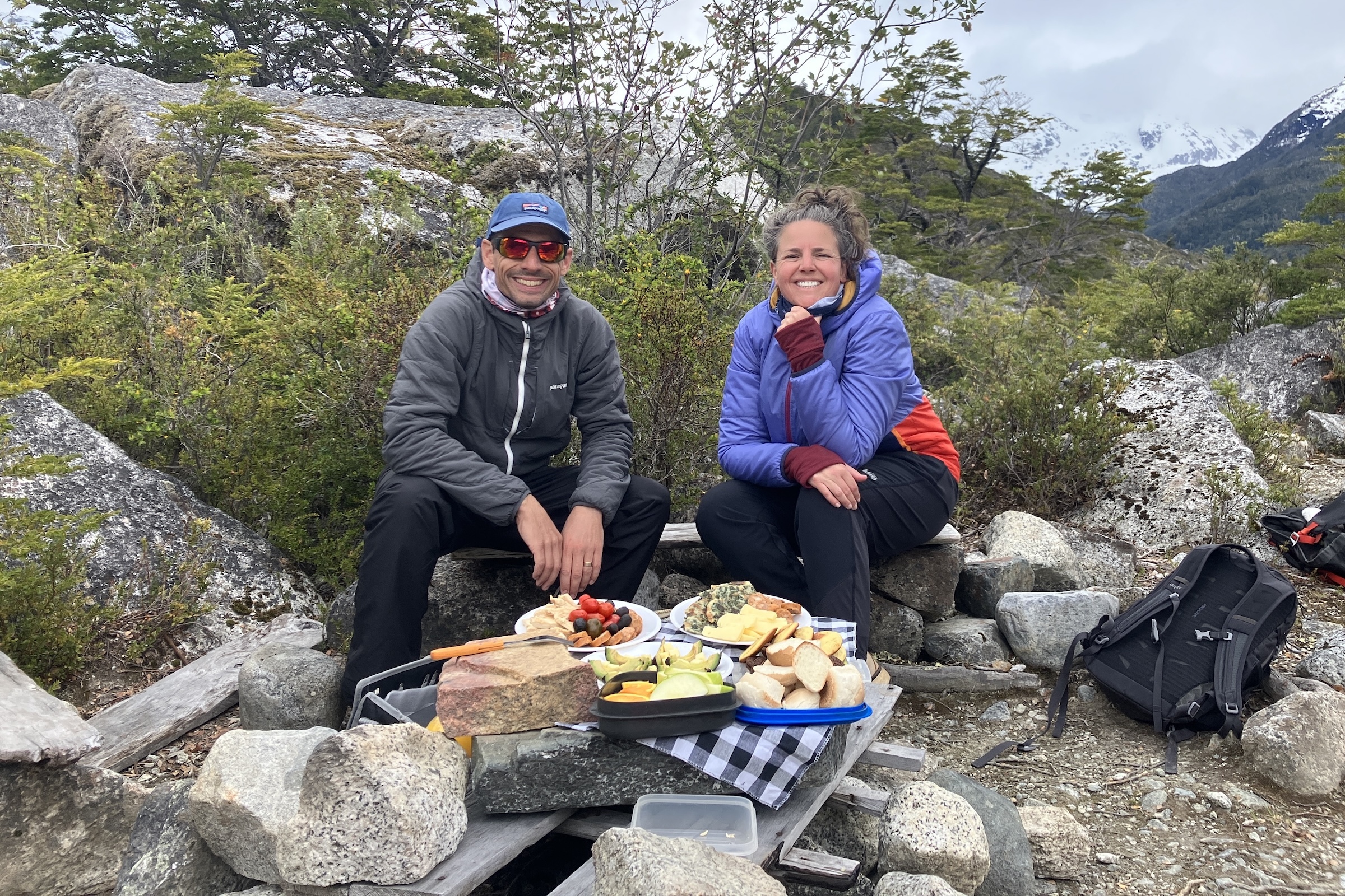 Two Swoop team members having lunch on the trail while hiking in Aysen
