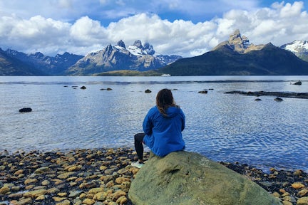 Tourist looking across water and mountains in Tierra del Fuego