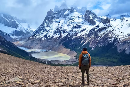 Hiker facing Cerro Torre on the Loma del Pliegue Tumbado day hike from EL Chaltén