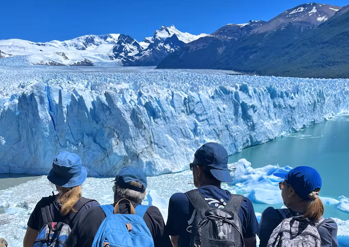Tourist at the viewpoint overlooking Perito Moreno glacier in Los Glaciares
