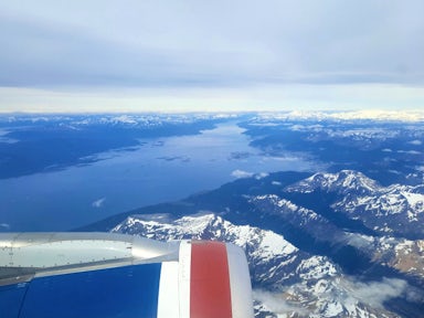 View from a plane window of Ushuaia, the mountains of Tierra del Fuego and the Beagle Channel