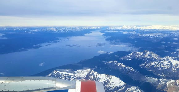 View from a plane window of Ushuaia, the mountains of Tierra del Fuego and the Beagle Channel