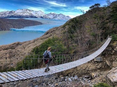 Crossing the hanging bridge over Grey Glacier Lake, Patagonia, Chile
