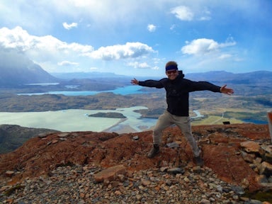 Man bracing the wind at the Mirador Ferrier, on Torres del Paine Hike, Chile