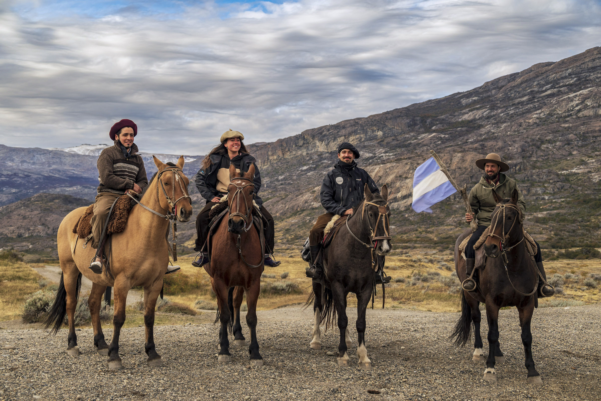 Four gauchos on horseback at an estancia in Los Glaciares