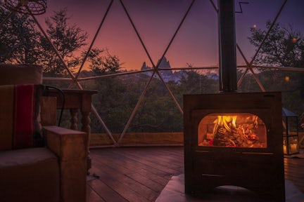 View of FitzRoy at night from glamping tent with log burner at Chaltén camp
