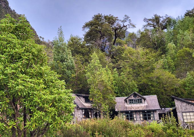 Wooden cabins of Caleta Gonzalo Lodge on the edge of the forest in Pumalín Douglas Tomplins National Park, Chile