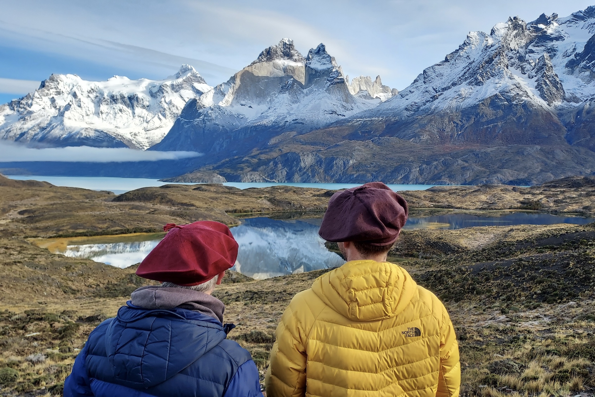 Two figures from behind looking at the Torres del Paine massif