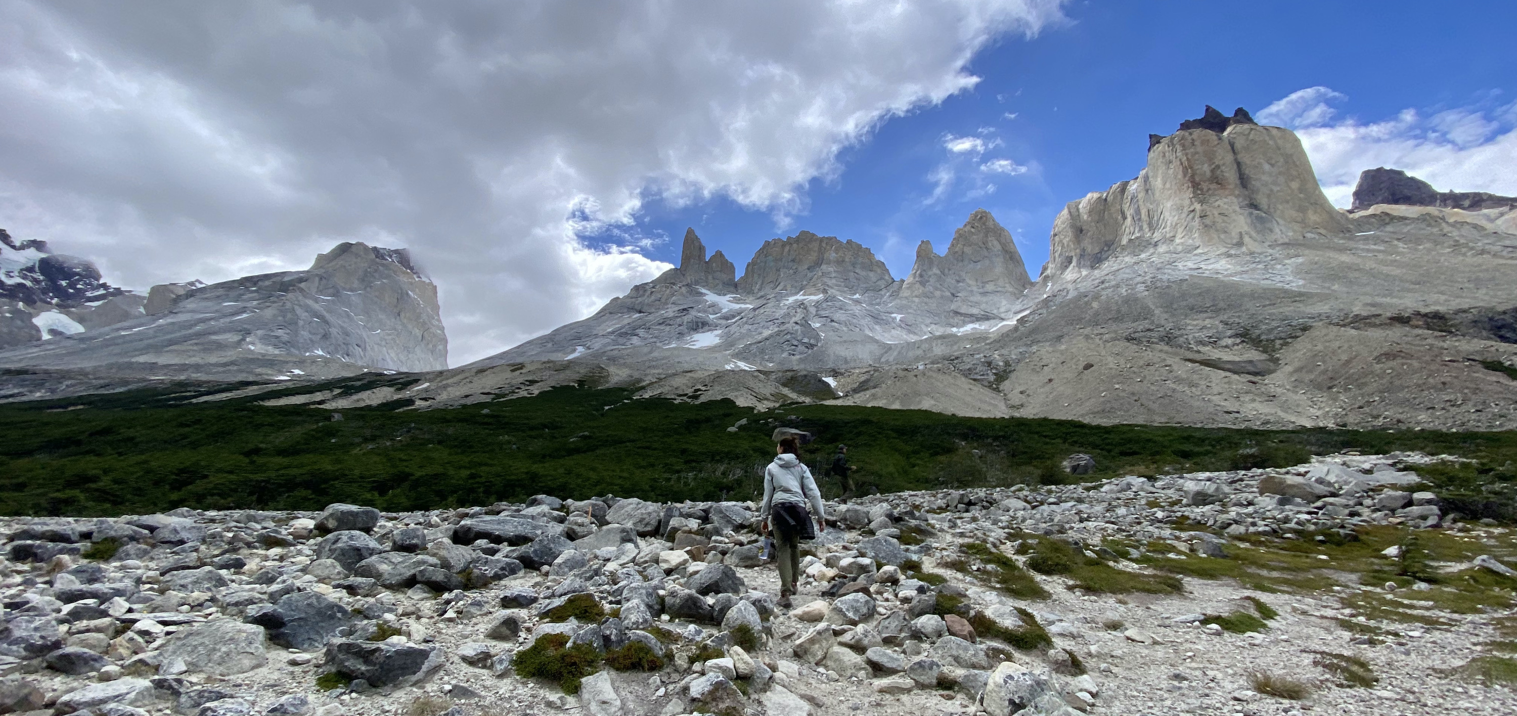 Hiker dwarfed by the Paine Massif