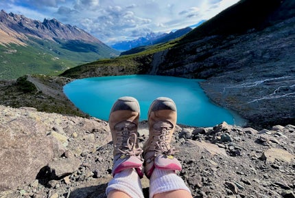 View over a hiker's feet to the Humuel glacier lake near Lago del Desierto