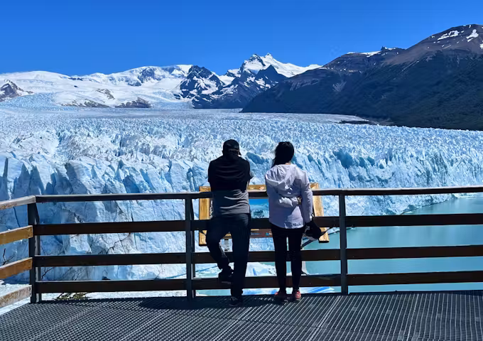 Two tourists at the viewing balconies at Perito Moreno glacier