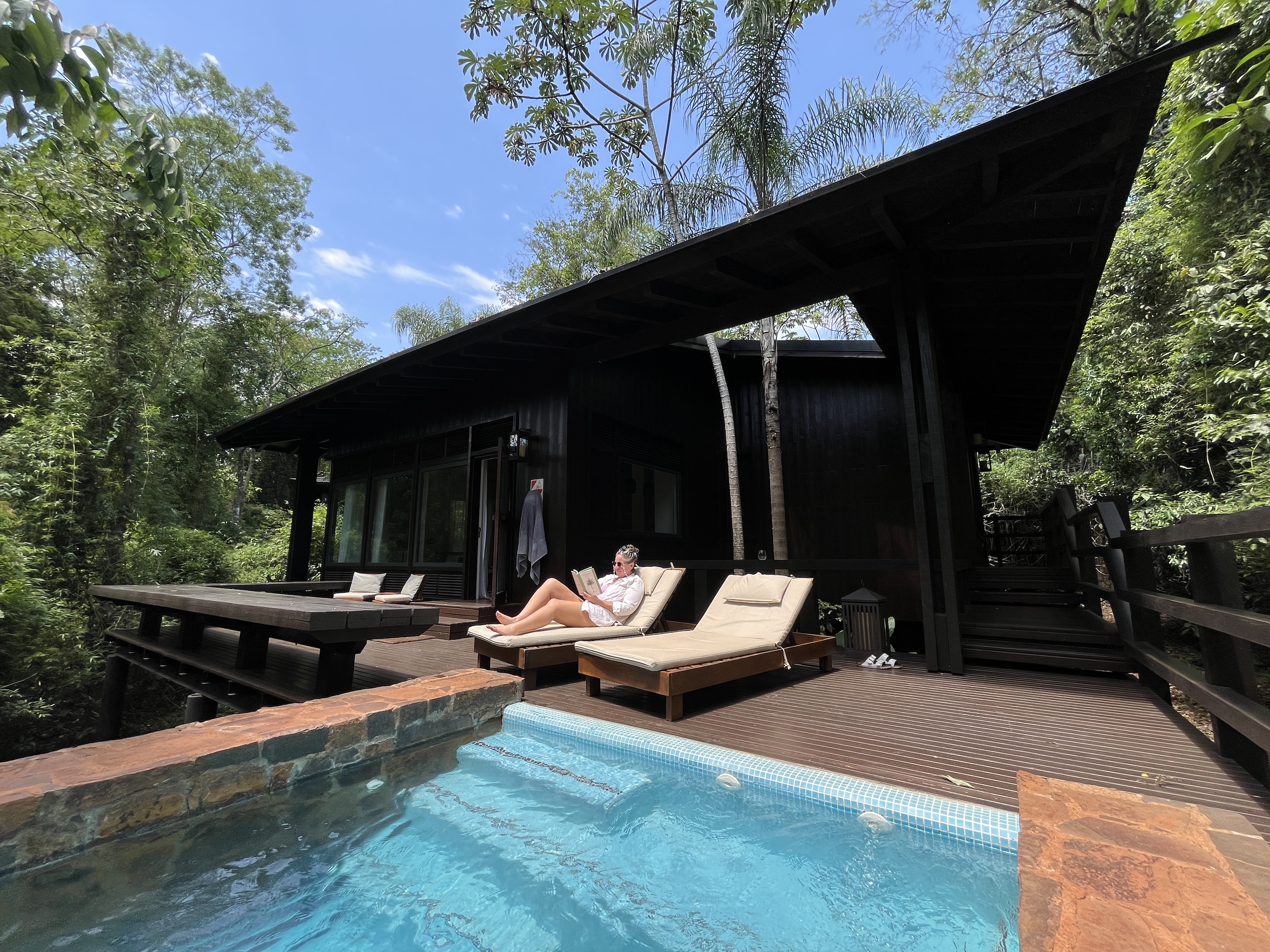 Sydney at Awasi Iguazu - reading by pool
