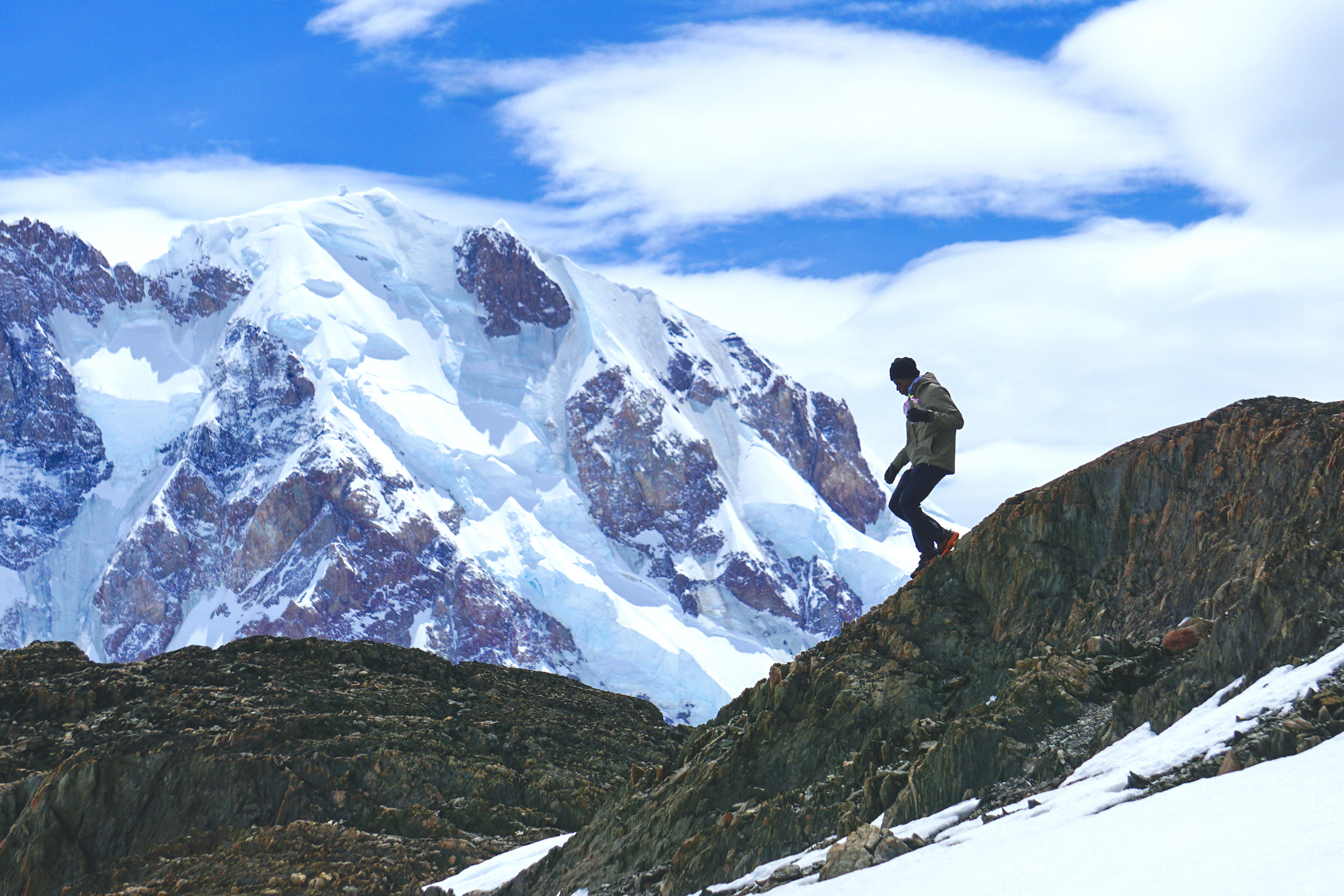 Hiker on a snowy ridge on the Huemul Circuit
