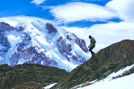 Hiker on a snowy ridge on the Huemul Circuit