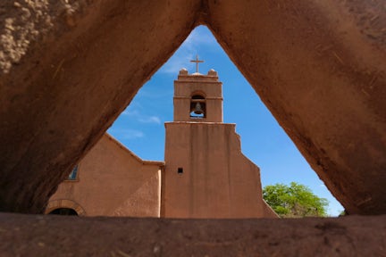 View of the tower of an adobe church in San Pedro de Atacama, Chile