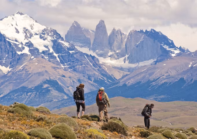 Three hikers looking at the towers of Torres del Paine, Torres del Paine Hike, Chile
